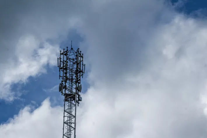 Cellphone tower with clouds in the background