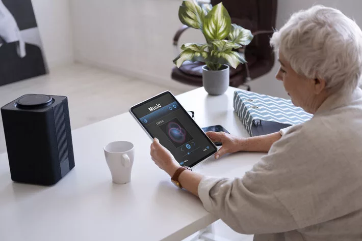 elderly woman working with digital assistant