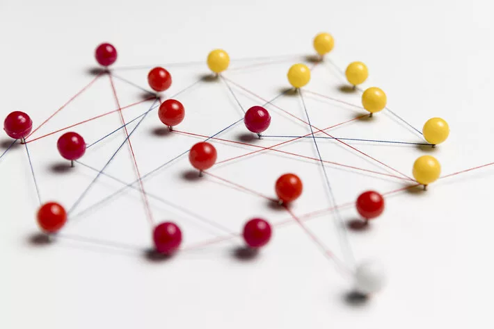 yellow red pushpins with thread route map